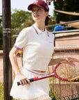 White cropped polo with puffed sleeves, oversized collar, and perforated detail
