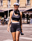 High Slit Contrast Active Shorts Navy styled with a women's tennis outfit, showcasing sporty activewear look, built-in liner, and comfortable athletic fit