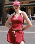 La Rose French Collar Tank Red styled with a women's tennis outfit, showcasing elegant sporty style, French inspired design, and flattering activewear fit