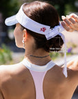 La Rose Ruffle Performance Visor White back detail, showcasing adjustable Velcro strap and eyewear slots for secure fit and sunglasses storage
