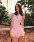 Model wearing mesh halter tank and petal tiered tennis skirt set, women’s tennis outfit front view