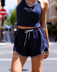 Navy active shorts contrast side stripe and high side-slit hem detail