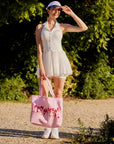 Oversized Court Tote Bag styled with a women's tennis outfit, showcasing a chic sporty look, spacious canvas design, and French-inspired active lifestyle style
