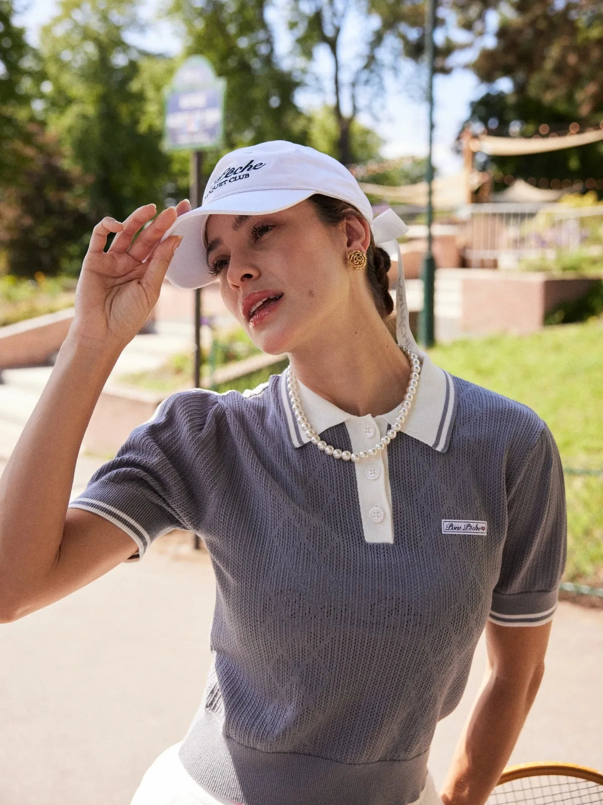 Model wearing Paris Racquet Club cap front view with structured fit