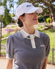 Side look of Paris Racquet Club cap with curved brim and structured crown on upper body