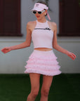 Pink Bow Halter Tennis Top with pink tennis visor and ruffle skirt, street-to-court athleisure look by Pom Pêche