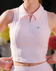 Poise™ pink half-zip polo worn by model front closeup, showing defined shoulder line and cropped length hitting below natural waist.