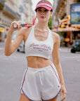 Poise Mesh Back Tank Top White styled with a tennis outfit, showcasing elegant sporty style, breathable activewear design, and confident athletic look