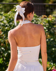 Poise Rose Halter Polo Tank White back view, showcasing halter-inspired open back design, breathable silhouette, and feminine rose embroidery detail
