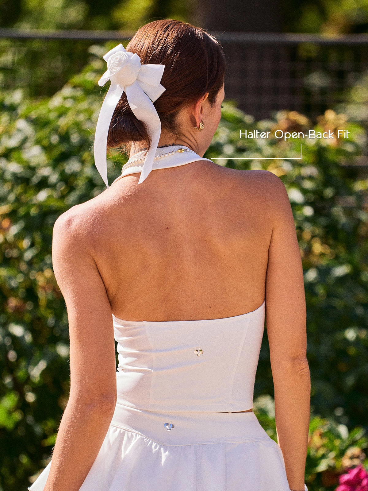 Poise Rose Halter Polo Tank White back view, showcasing halter-inspired open back design, breathable silhouette, and feminine rose embroidery detail