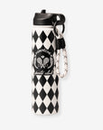 Pom Pêche 750ml Insulated Tumbler with Straw Lid in black and white – harlequin diamond print stainless steel body with Pom Pêche Sports Club Paris circular crest badge, black straw lid and black-and-white braided carry strap on white background