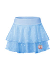 Flat lay of Pom Pêche x Betty Boop Cake Skirt in Paris blue – wide sky blue high waistband, double-layer lightweight polka dot mesh ruffle tiers and Betty Boop Pom Pêche circular badge on white background