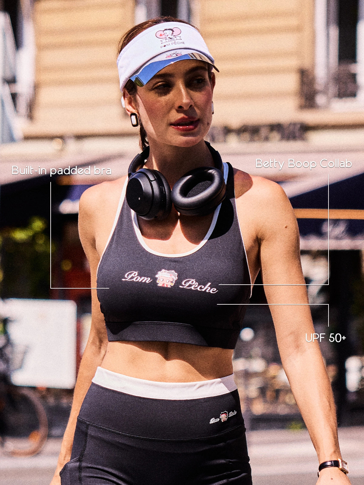 Close-up of Pom Pêche x Betty Boop black tank top with feature callouts – built-in padded bra, Betty Boop collab logo print and UPF 50+ cooling performance fabric