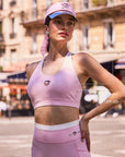 Close-up of Pom Pêche x Betty Boop pink tank top with feature callouts – built-in padded bra, Betty Boop collab logo print and UPF 50+ cooling LYCRA® performance fabric annotated