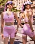 Pom Pêche x Betty Boop pink mesh back tank top – front and back view showing scoop neckline and racerback silhouette, styled with matching pink shorts and Pom Pêche visor on Paris street