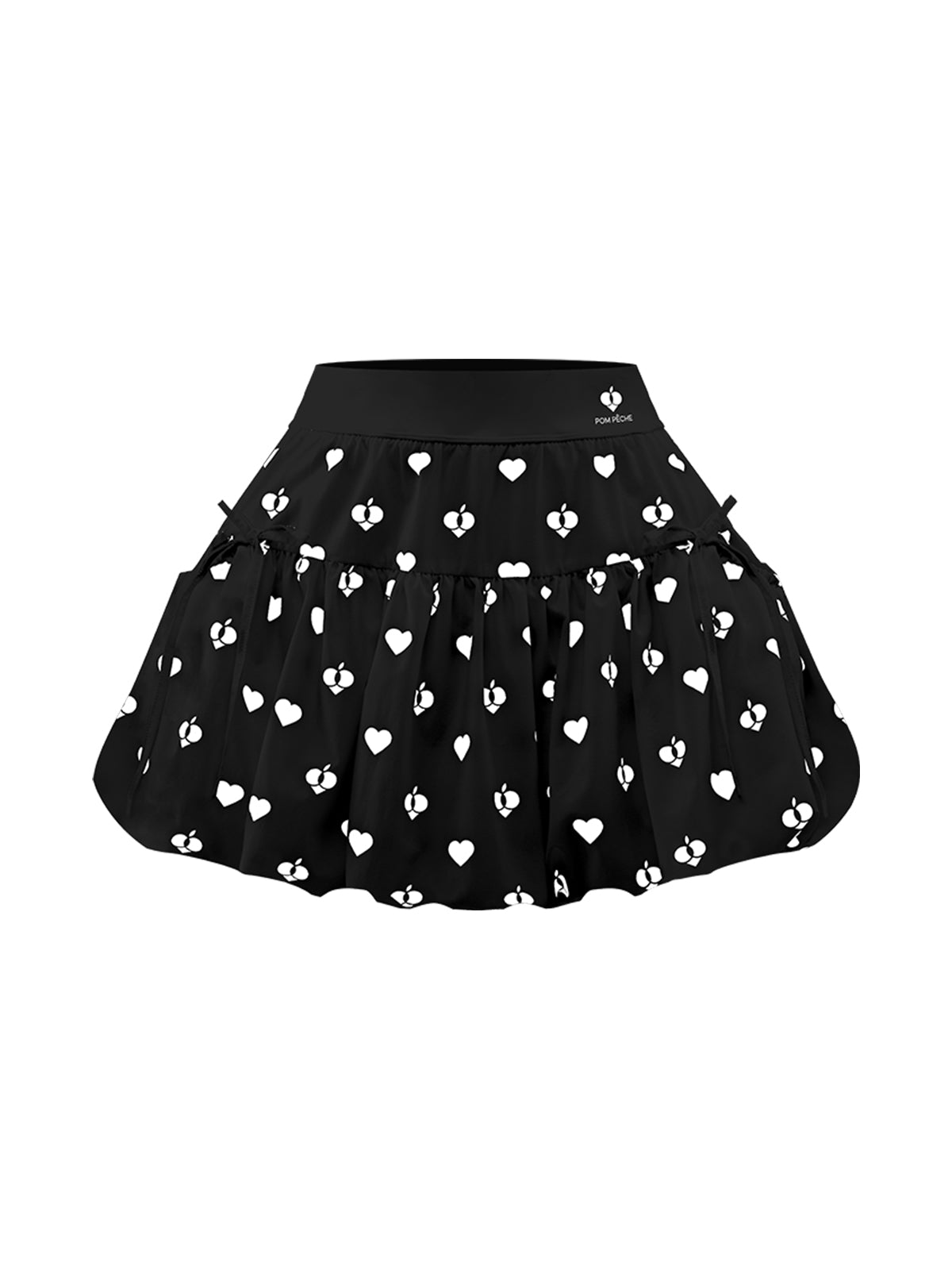 Flat lay of Pom Pêche Bubble A-Line Tennis Skirt in black – high-waisted band with Pom Pêche logo, voluminous bubble hem with white heart and logo allover print on white background