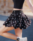 Pom Pêche black Bubble A-Line Skirt feature callout – French bow detail at waist and high-waist bubble A-line silhouette for sculpted waist and balanced hip ratio, heart logo print
