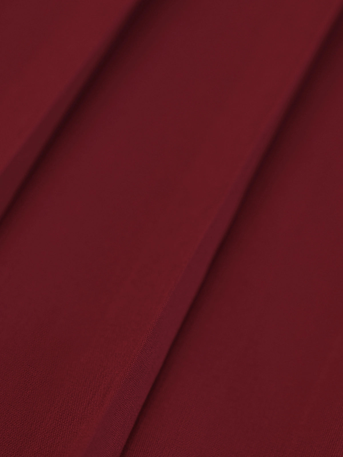 Macro fabric detail of Pom Pêche wine red Classic Pleated Tennis Skirt showing fine knife pleats with smooth matte cool-touch lightweight woven texture – breathable and anti-static performance fabric