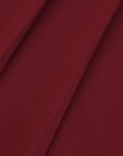 Macro fabric detail of Pom Pêche wine red Classic Pleated Tennis Skirt showing fine knife pleats with smooth matte cool-touch lightweight woven texture – breathable and anti-static performance fabric