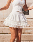 Pom Pêche LaRose tiered tennis skirt feature callout – fine pleated outer layer for hip-slimming effect and three-tier irregular pleated mesh underlayers for airy volume and fluid movement