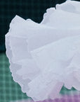 Macro detail of Pom Pêche white Petal Tiered Skirt showing three-tier lightweight chiffon layers with scalloped petal edges – soft, breathable and quick-drying performance fabric