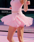 Pom Pêche light pink Petal Tiered Skirt in motion with feature callouts – high-waisted flattering silhouette with Pom Pêche logo and layered petal chiffon hem flaring during run