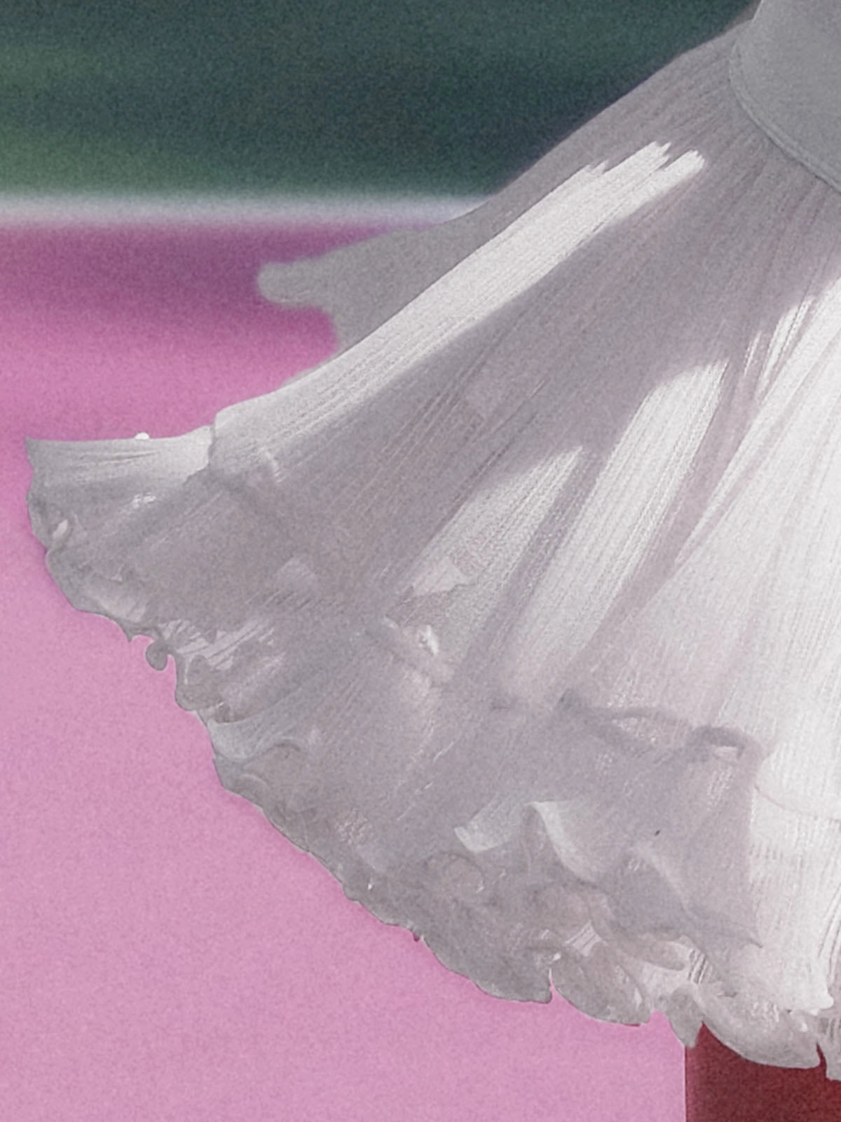 Macro detail of Pom Pêche white Rose Ruffle Skirt showing fine pleated airy mesh outer layer with double-tier petal-like scalloped ruffle hem flaring in motion – lightweight cool-touch UPF 50+ fabric