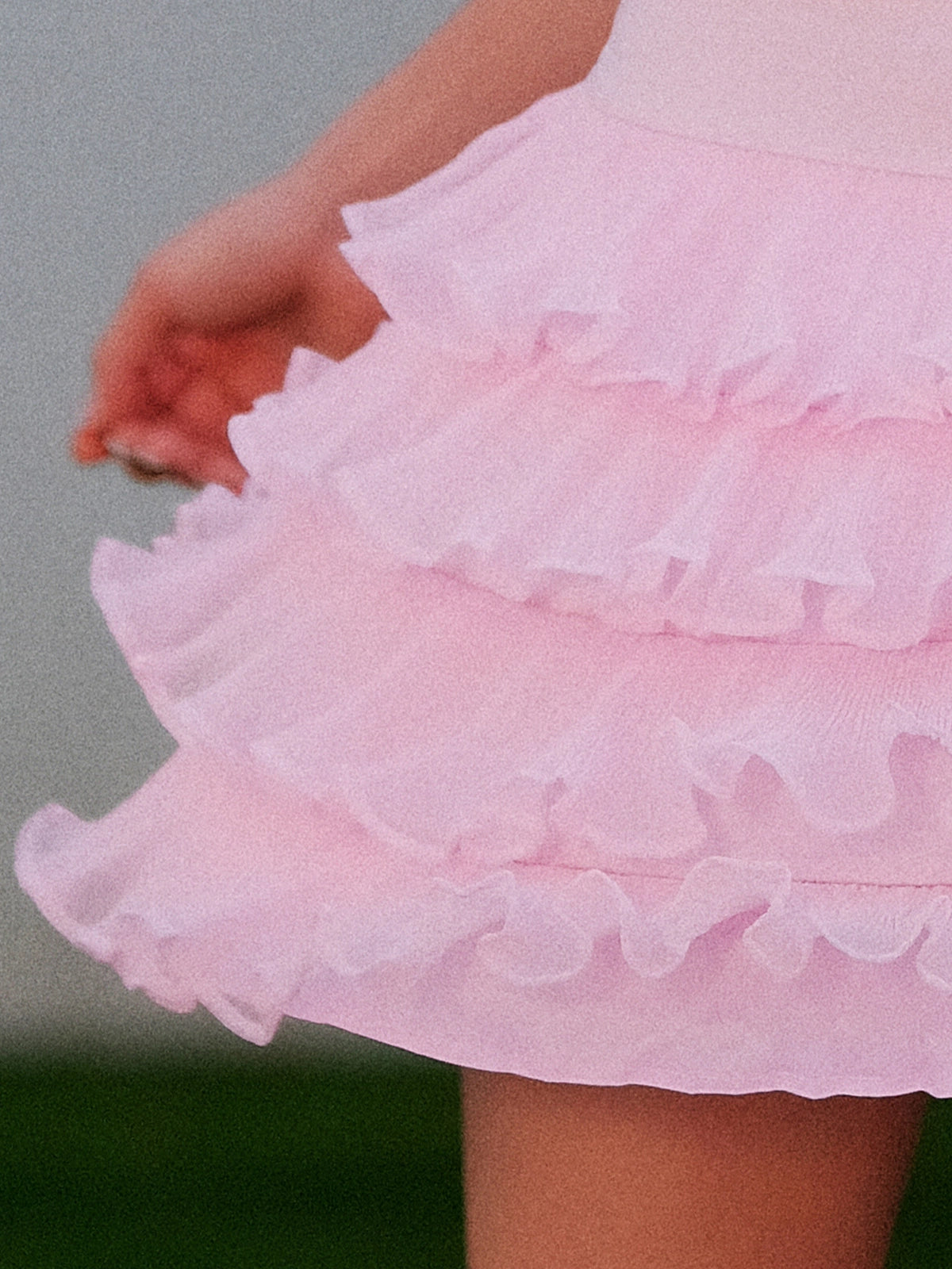 Macro detail of Pom Pêche pink Ruffle Cake Skirt showing 5-tier lightweight fine tulle ruffle layers with scalloped edges – soft, airy cool-touch fabric with graceful movement