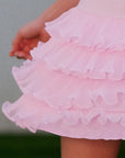 Macro detail of Pom Pêche pink Ruffle Cake Skirt showing 5-tier lightweight fine tulle ruffle layers with scalloped edges – soft, airy cool-touch fabric with graceful movement
