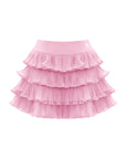 Flat lay of Pom Pêche Ruffle Cake Skirt in blush pink – structured high waistband with Pom Pêche logo, five graduated tulle ruffle tiers creating full A-line cake skirt silhouette