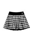 Flat lay of Pom Pêche Spin™ Diamond Mesh Skirt in black – wide black high waistband with Pom Pêche crown logo, voluminous black and white harlequin diamond print high-density mesh tulle skirt on white background