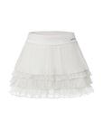 Flat lay of Pom Pêche Spin™ LaRose Pleated Tiered Skirt in white – structured high waistband with metallic logo, fine pleated outer layer and three-tier mesh ruffle hem on white background