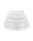Flat lay of Pom Pêche Spin™ Mille Tiered Skirt in white – structured high waistband with Pom Pêche logo, four graduated tulle ruffle layers creating full A-line silhouette on white background