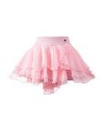 Flat lay of Pom Pêche Spin™ Petal Tiered Tennis Skirt in light pink – high-waisted band with Pom Pêche crown logo, three-tier asymmetric petal chiffon hem on white background