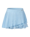 Flat lay of Pom Pêche Spin™ Waltz Layered Tennis Skirt in sky blue – high-waisted band with silver Pom Pêche logo, fine pleated outer layer and asymmetric double-tier white mesh ruffle hem on white background