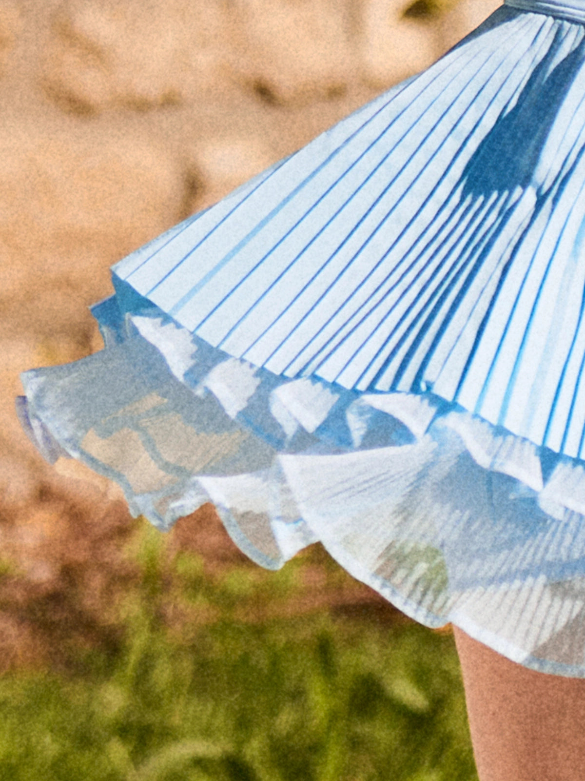 Macro detail of Pom Pêche sky blue Waltz Skirt showing fine pleated LYCRA® outer layer over double-tier white sheer mesh ruffle hem – lightweight anti-static 4-way stretch fabric