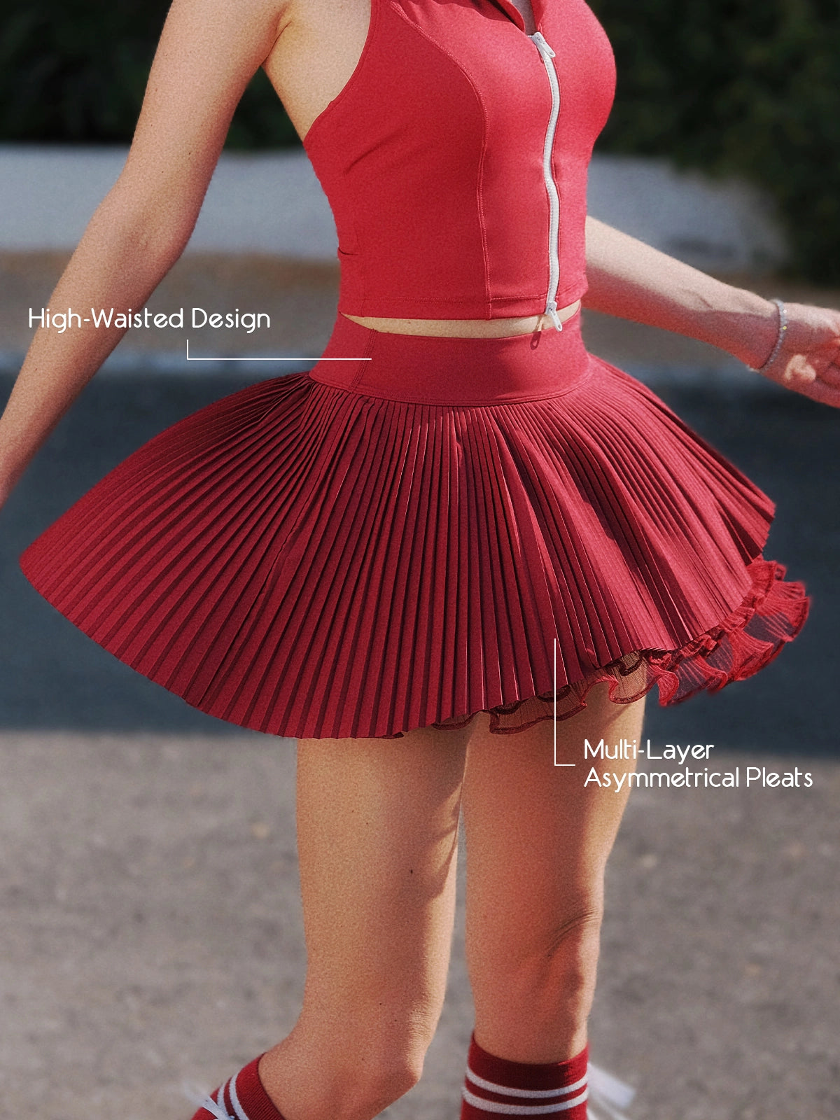 Pom Pêche wine red Waltz tennis skirt with feature callouts – high-waisted sculpting waistband for tummy support and multi-layer asymmetrical pleats for a fluid silhouette