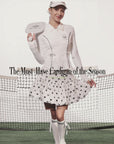 Black sun-protective tennis jacket with a sculpted fit, adjustable waist ties, and dual ball pockets.