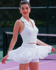 Model wearing white rose halter tank and petal tiered tennis skirt set, flattering women’s tennis outfit front view