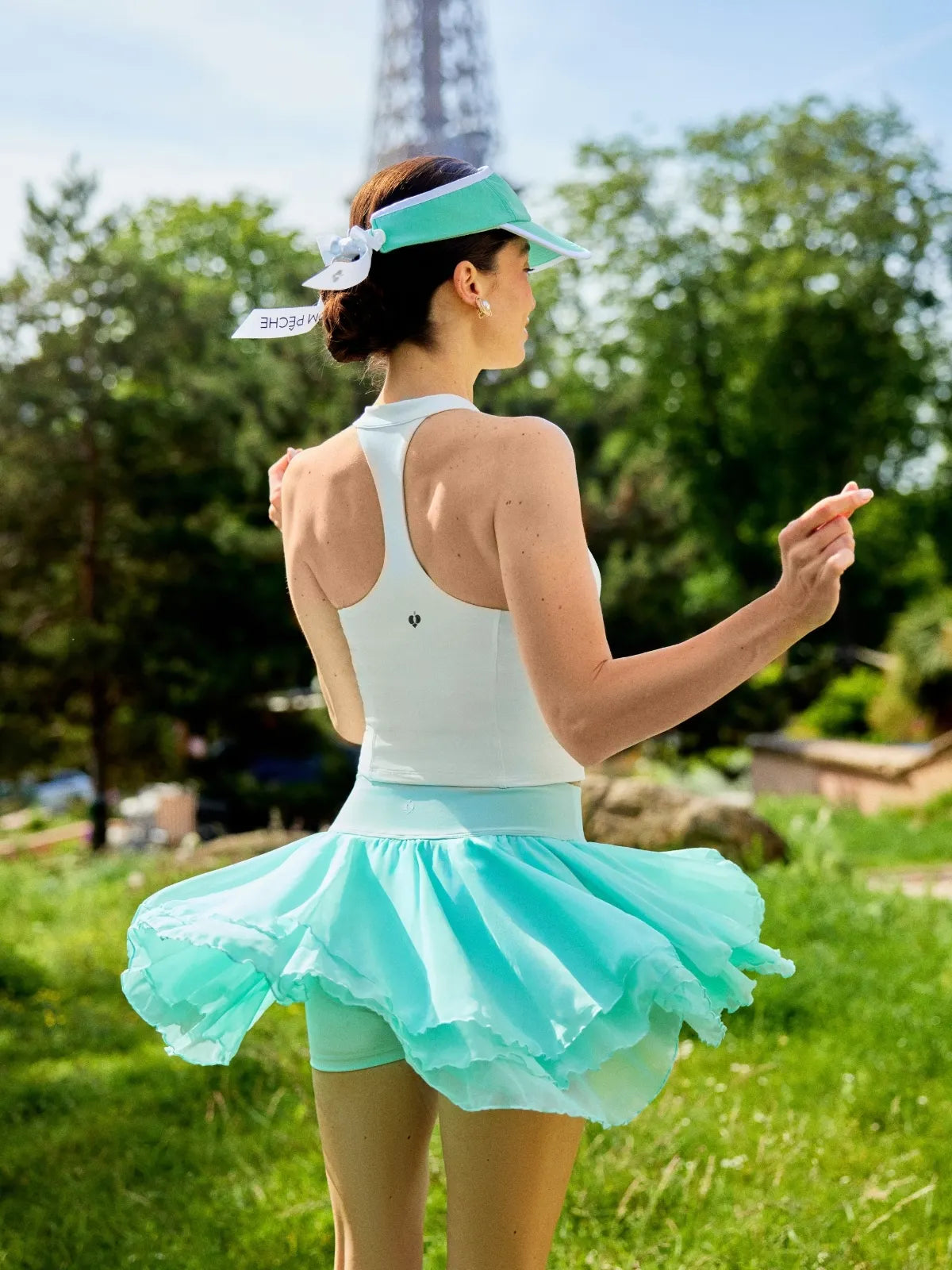 Spin Mesh Fairy Tennis Skirt Mint Green back view, showcasing three tier tulip hem design, flattering silhouette, and elegant sporty tennis skort style