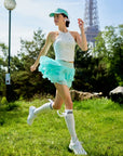 Spin Mesh Fairy Tennis Skirt Mint Green in Paris lifestyle scene, showcasing a flowy tulip hem tennis skort, built-in shorts, and elegant sporty movement