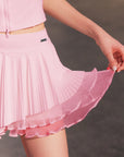 Close-up of Spin™ Waltz Layered Skirt with flowing asymmetric pleats and soft layered fabric texture