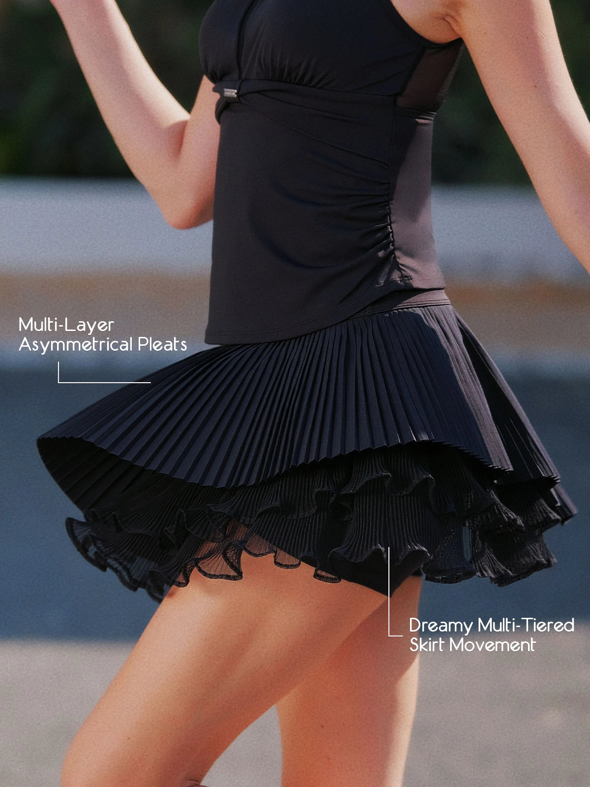Spin Waltz Layered Skirt Black detail, showcasing multi-layer asymmetric pleats, lightweight flowing design, and dynamic movement