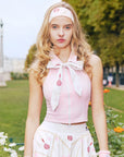 Close-up view of Pink Tennis Zip Tank Top with half-zip front, halter neckline, and refined fabric details