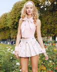 Styling look featuring Pink Tennis Zip Tank Top paired with a tennis skirt for an elegant court-to-café outfit