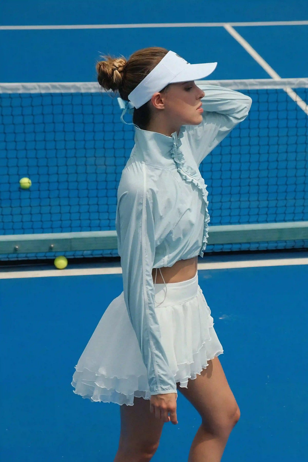 Model wearing UPF cropped sun jacket outdoors, lightweight sun protection jacket for tennis and active lifestyle