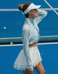 Model wearing UPF cropped sun jacket outdoors, lightweight sun protection jacket for tennis and active lifestyle