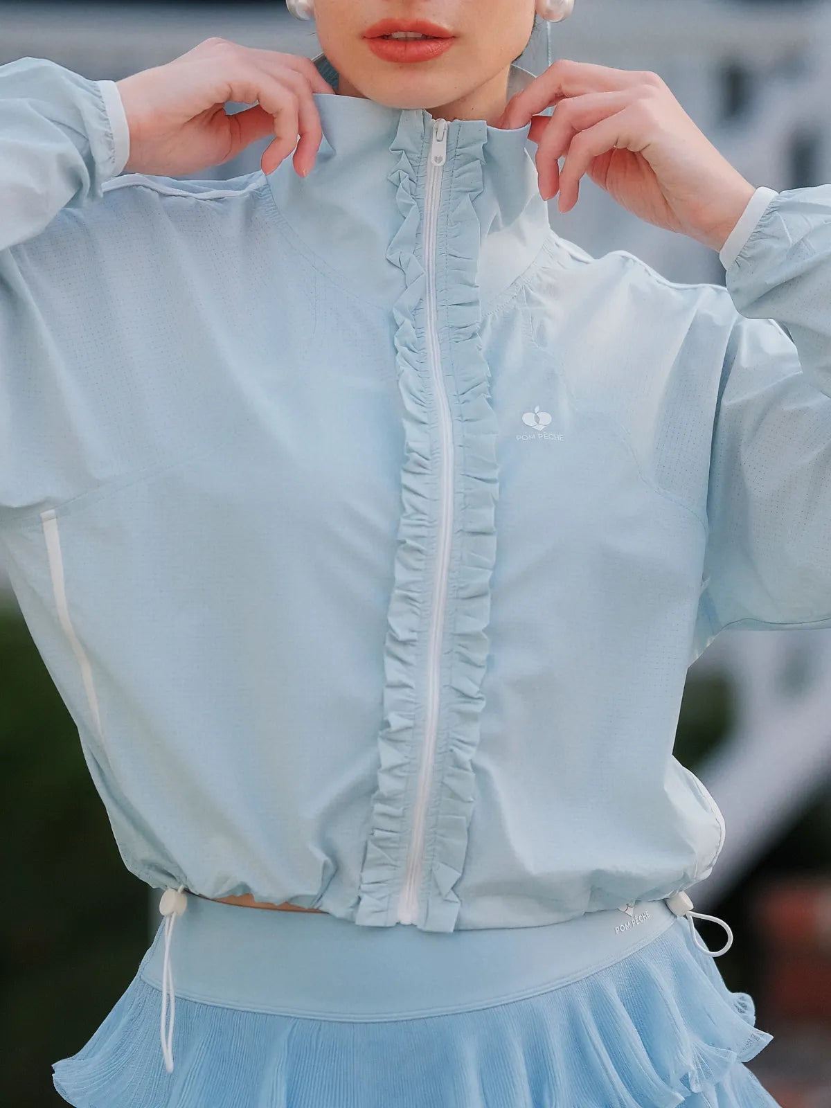 Close-up of UPF cropped sun jacket zipper detail, lightweight women’s outdoor sports jacket