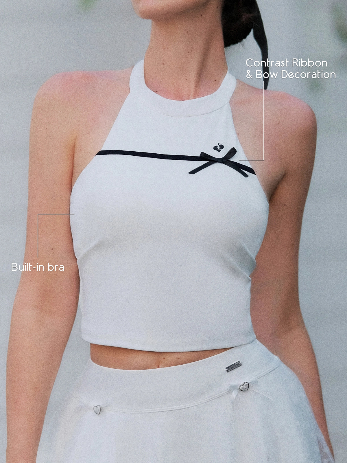White Bow Halter Tennis Top – contrast black ribbon bow and built-in bra callout, sculpting halter neckline detail
