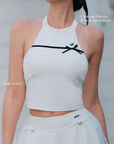 White Bow Halter Tennis Top – contrast black ribbon bow and built-in bra callout, sculpting halter neckline detail